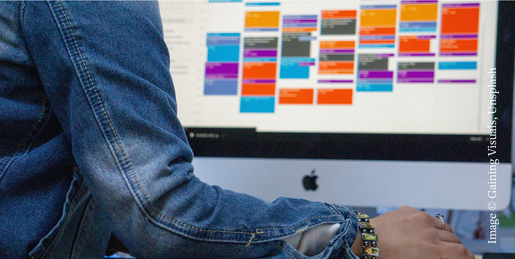 A stock photo of someone in a denim jacket using google calendar